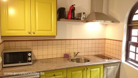 Kitchen with yellow cabinets and microwave – La Matanza, Tenerife