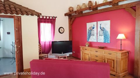 Living room with red wall and television – La Matanza, Tenerife