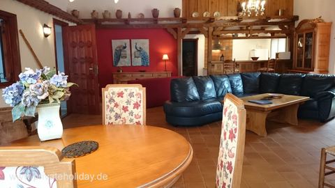 Dining area with wooden table and flower vases – La Matanza, Tenerife
