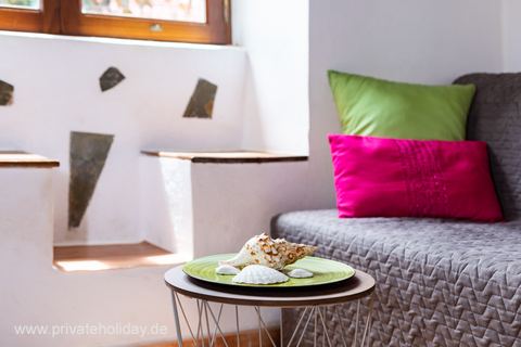 Sofa with colorful cushions and side table – Igueste de San Andrés, Tenerife