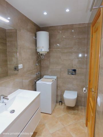 Modern bathroom with washing machine and toilet – Costa Calma, Fuerteventura