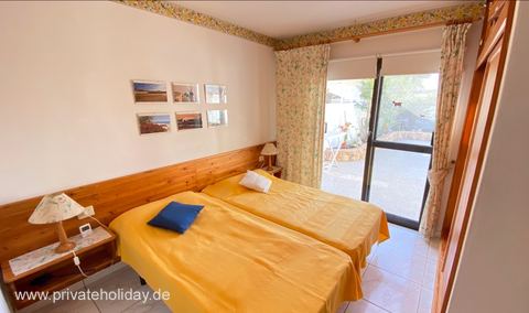 Dormitorio con cama doble y puerta al patio – Costa Calma, Fuerteventura