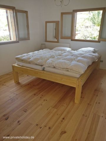 Bright bedroom with double bed and wooden floor – Chio, Tenerife