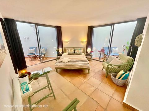 Dormitorio con dos puertas al patio y sillones – Costa Calma, Fuerteventura