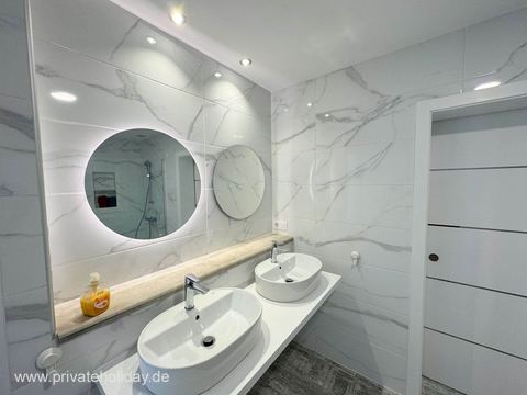 Modern bathroom with double sink and round mirrors – Costa Calma, Fuerteventura