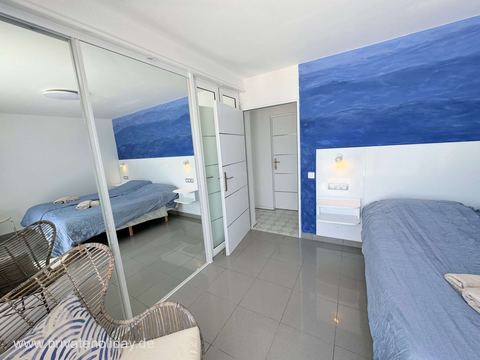 Bedroom with wardrobe and rattan chair – Costa Calma, Fuerteventura