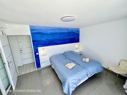 Bright bedroom with double bed and ocean wall – Costa Calma, Fuerteventura