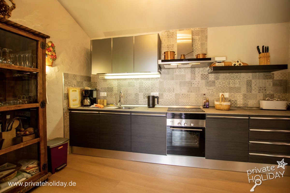 Kitchen with dark cabinets and oven – Guía de Isora, Tenerife
