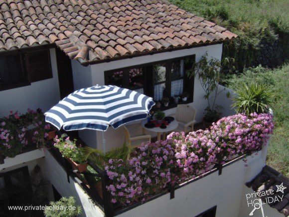 Balcony with flowers and striped umbrella – Icod de los Vinos, Tenerife