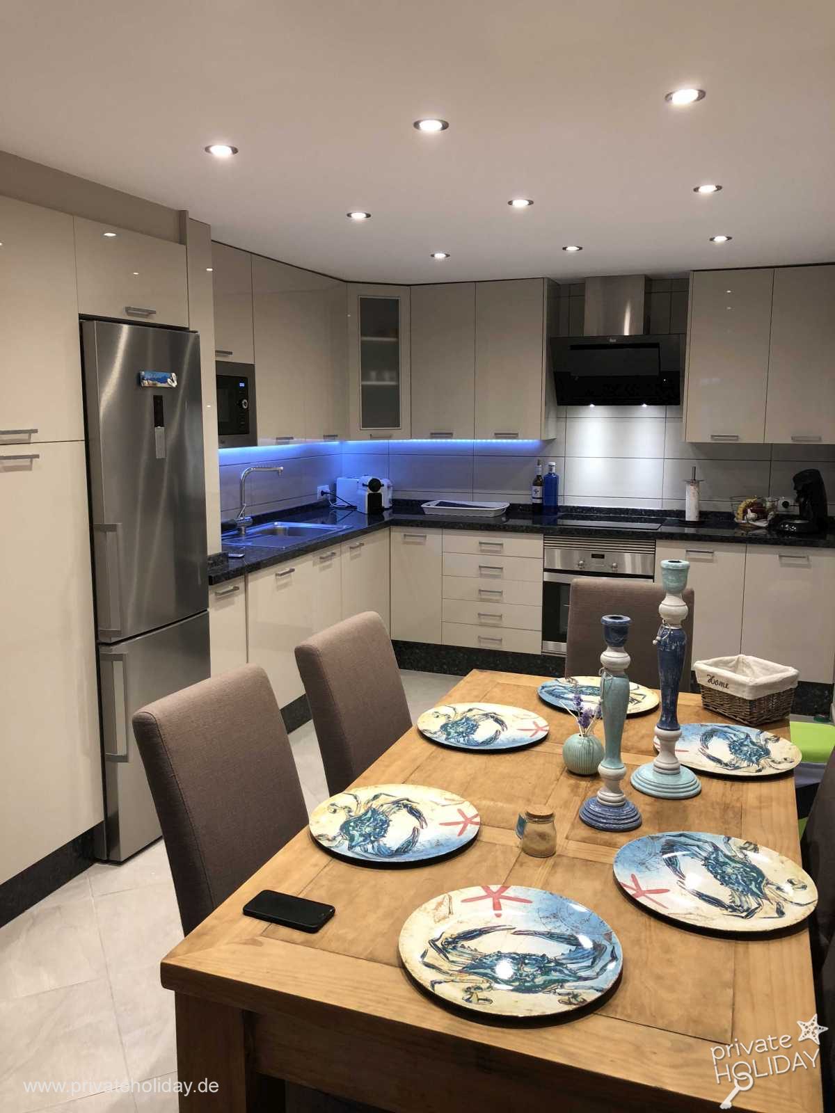 Modern kitchen with dining table and steel fridge – Costa Calma, Fuerteventura