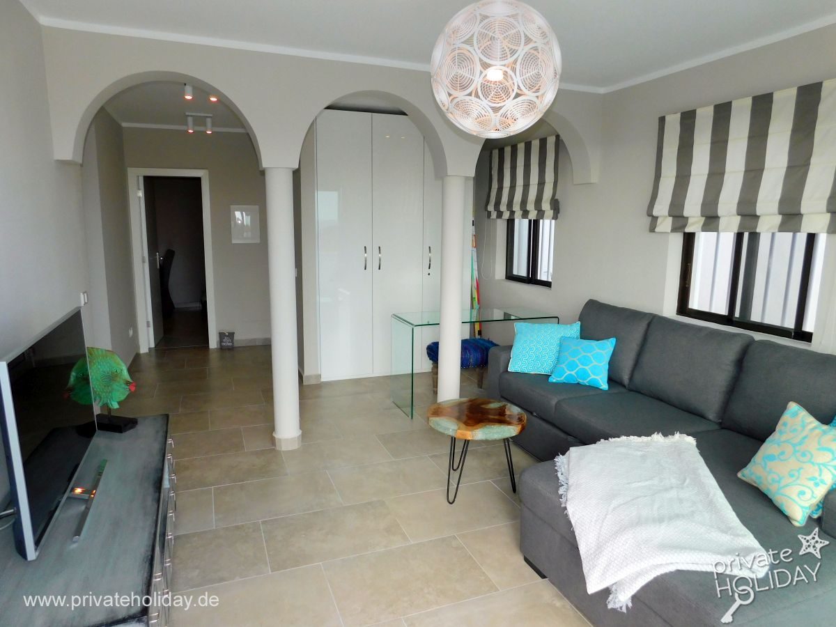 Living room with gray sectional sofa and TV – Costa Calma, Fuerteventura