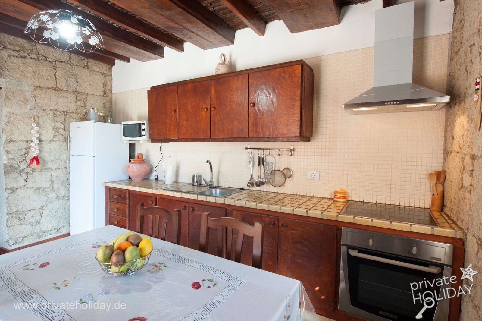 Cocina con mesa de comedor y armarios de madera – Arico, Tenerife