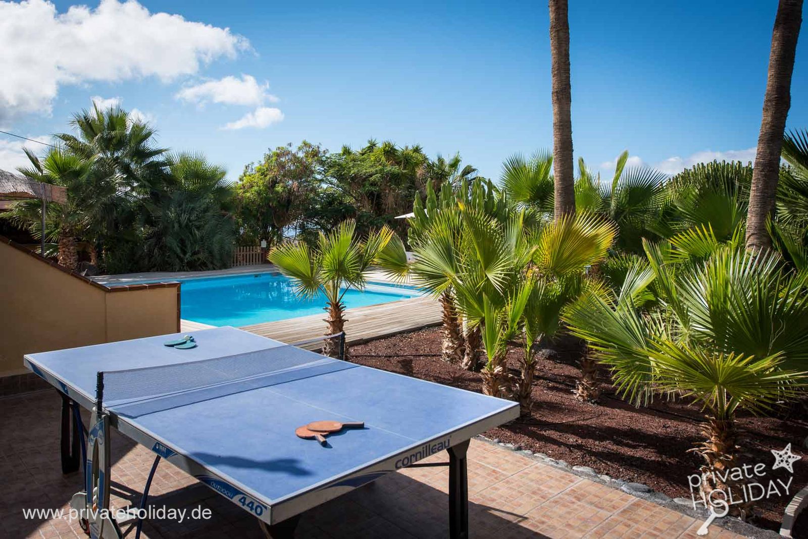 Table tennis table with pool and palms behind – Guía de Isora, Tenerife
