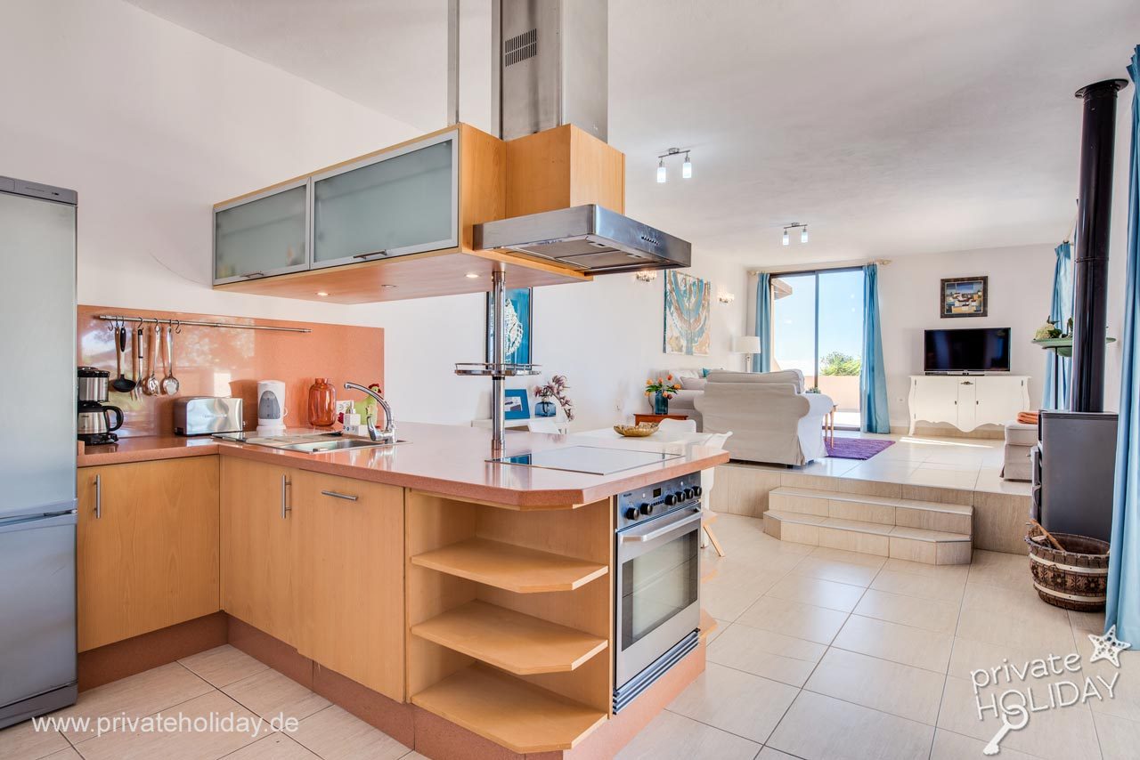 Open kitchen with living area and patio door – Guía de Isora, Tenerife